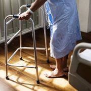 older person walking with frame