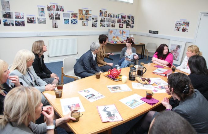 What are the benefits and costs of providing peer support to parents of disabled children?