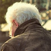 Older man alone on park bench