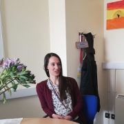 Researcher sits in front of whiteboard