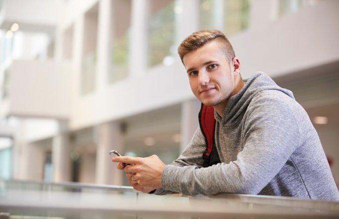 Young adult male looks to camera