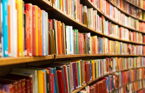 Library with many shelves and books, diminishing perspective