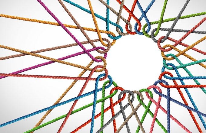Unity and connection partnership as ropes shaped as a circle in a group of diverse strings connected together shaped as a support symbol expressing the feeling of teamwork and togetherness.