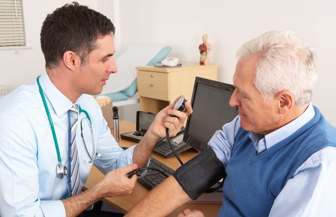 Gp in consulatation with patient