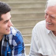 Young man sharing the music with his grandfather