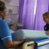 Two nurses work together to change an empty hospital bed