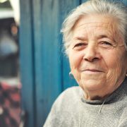 Happy old senior woman smiling outdoor portrait