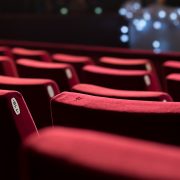Rows of red velvet empty theatre chairs