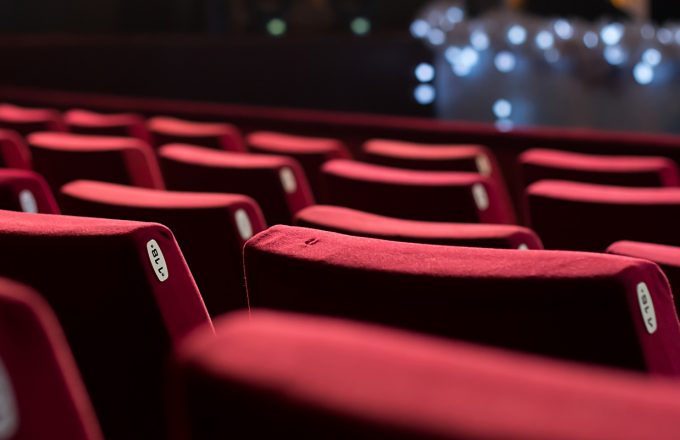 Rows of red velvet empty theatre chairs