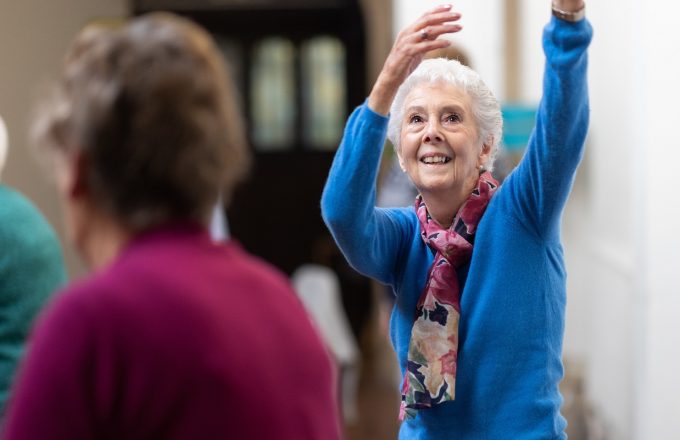 An older lady exercising in a class