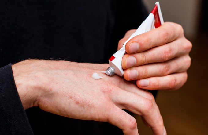 applying an emollient to dry flaky skin as in the treatment of psoriasis, eczema and other dry skin conditions