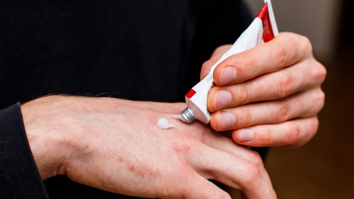 applying an emollient to dry flaky skin as in the treatment of psoriasis, eczema and other dry skin conditions