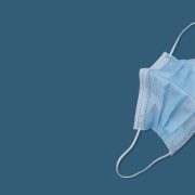 A face mask on a plain blue background.