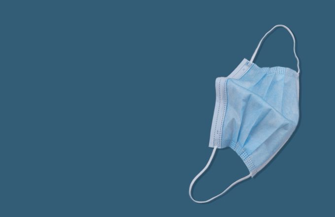 A face mask on a plain blue background.