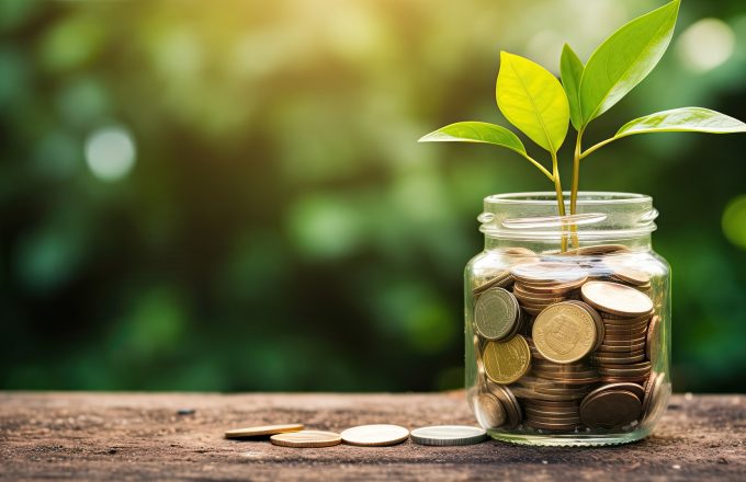 plant growing out of coins in glass jar