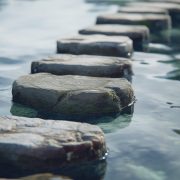 Row of stepping stones in body of water