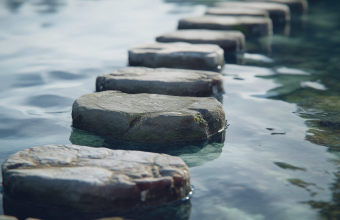 Row of stepping stones in body of water