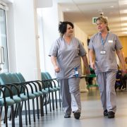 Healthcare professionals walking in a hospital corridor