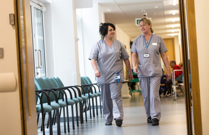 Healthcare professionals walking in a hospital corridor